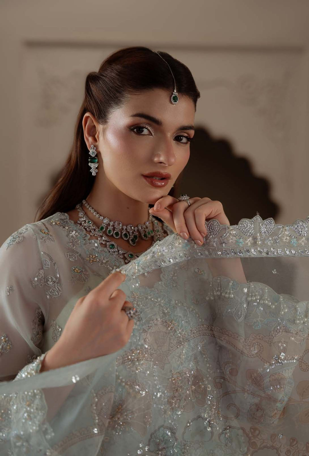 Close portrait holding the edge of Celeste's sheer dupatta