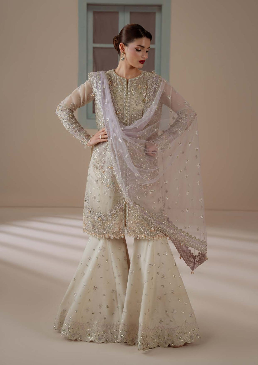 Enamour with a hand on the hip, the flared sharara visible