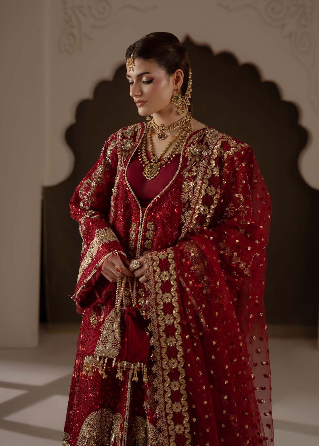 Amour, three-quarter view with the dupatta and a small potli bag