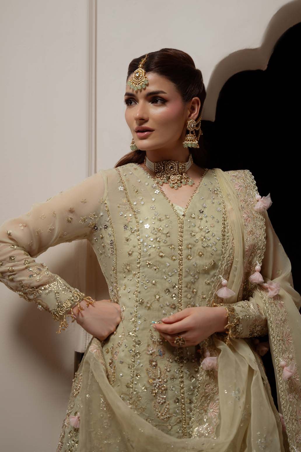 Close portrait of the model wearing Reverie with a gold choker and earrings