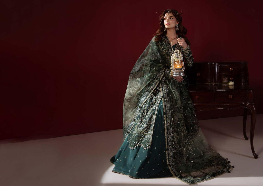 Elysee, seated, with the dupatta draped over a flared emerald skirt