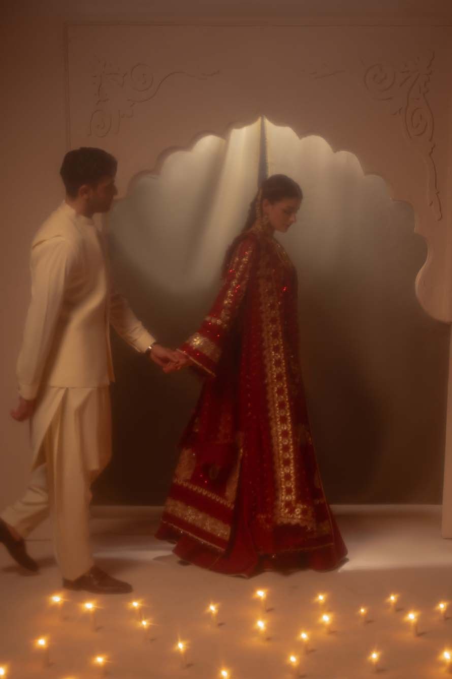 The model in Amour walking hand in hand with a man in cream