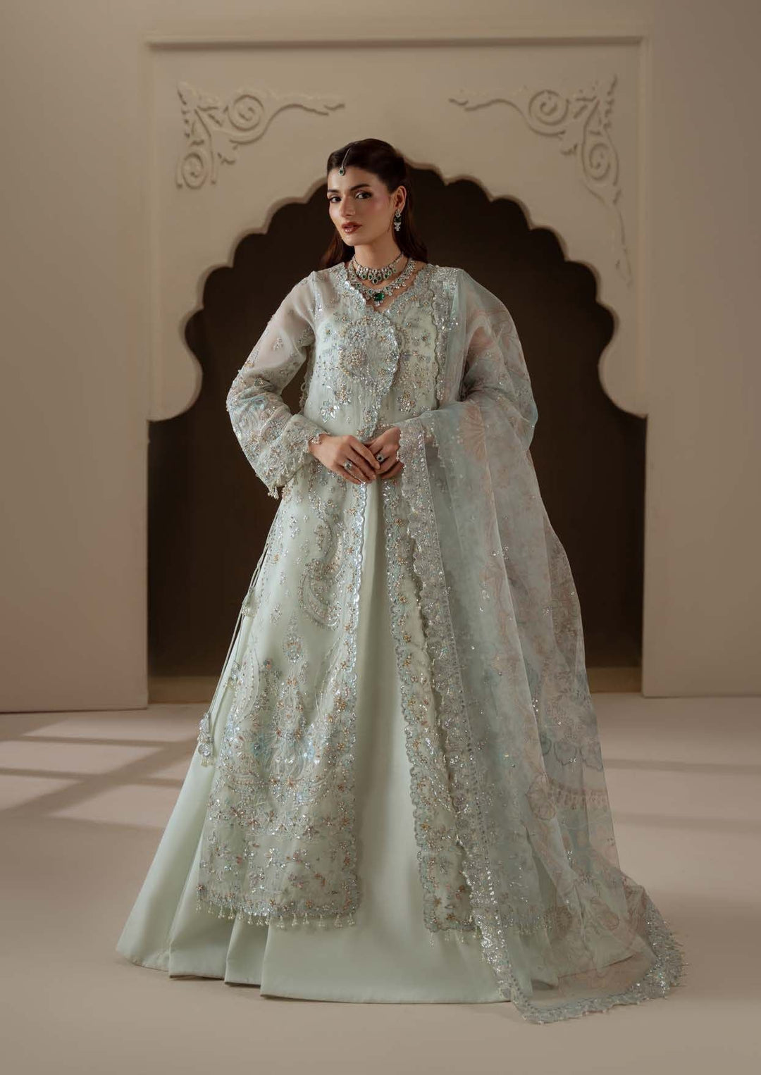 Celeste standing in an arched doorway: a pale mint long shirt with a sheer dupatta