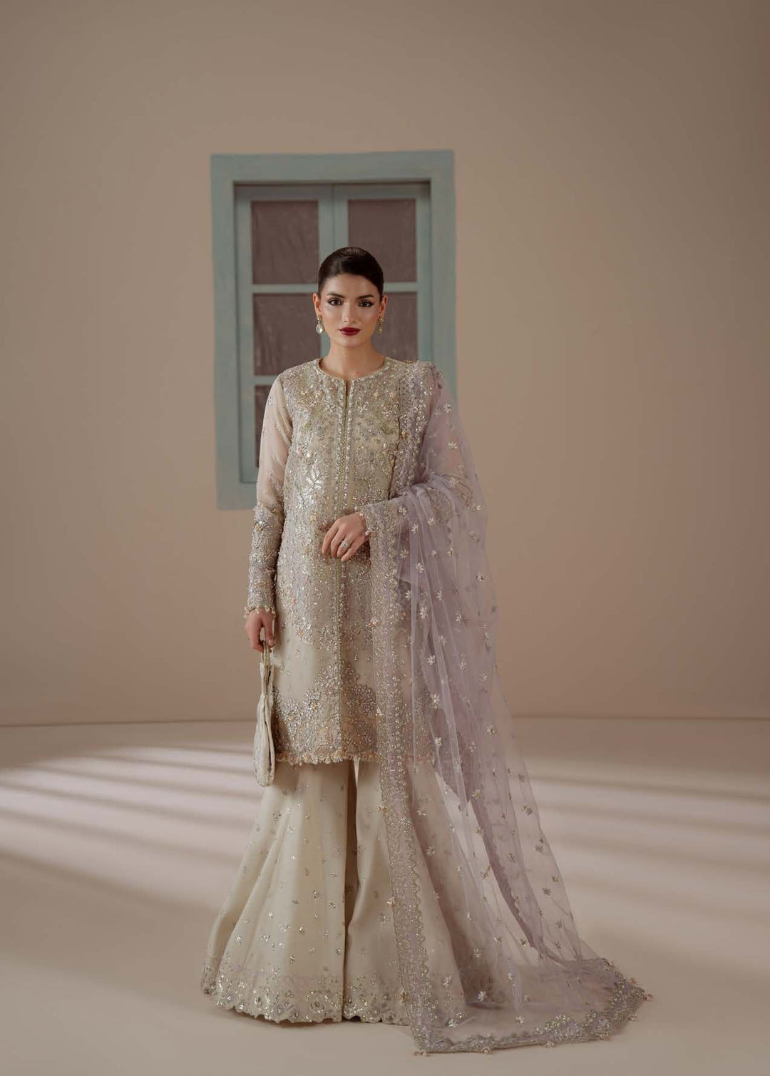 Enamour: a short champagne embellished shirt, flared sharara and a lilac dupatta