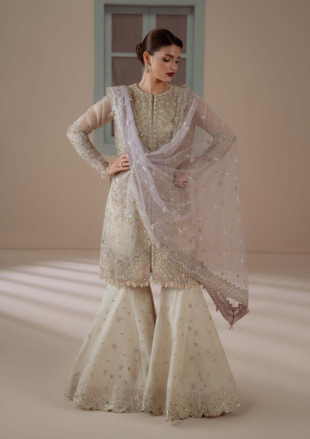 Enamour with a hand on the hip, the flared sharara visible